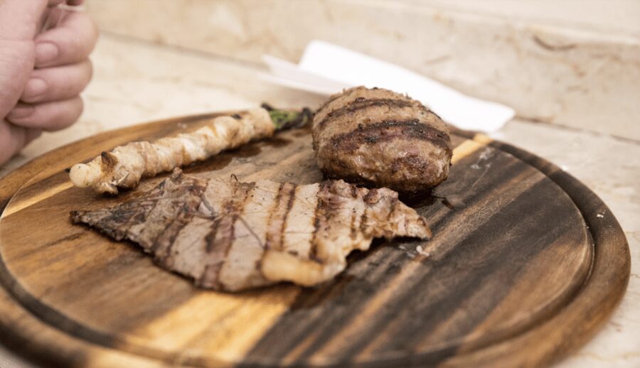 Catania Street food tour by night - La Pescheria choices: fried seafood cone or grilled horse meat meatball