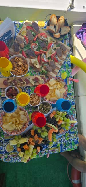 Cefalù: Coast-to-coast boat day trip with snorkeling and aperitif - The onboard aperitif: prosecco, limoncello, and real Sicilian snacks