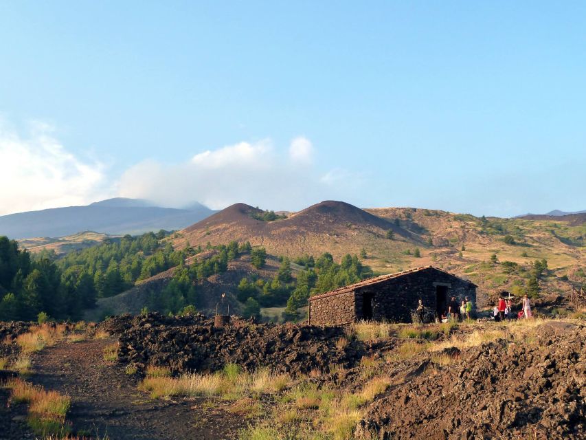 From Catania: Mount Etna Sunset Tour with Aperitif - The volcanic cave stop: helmets, flashlights, and cool air