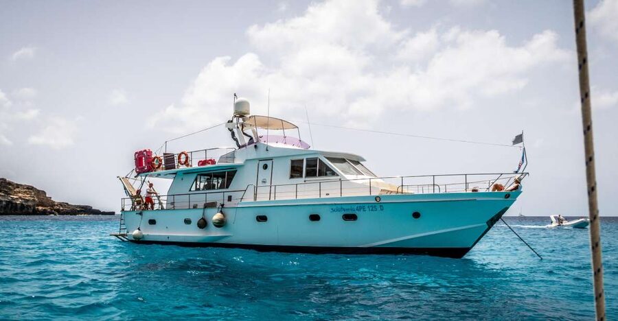 Lampedusa: Yacht excursion, swimming stops and typical lunch - Punta Muro Vecchio: north-coast sapphire water and caves up close